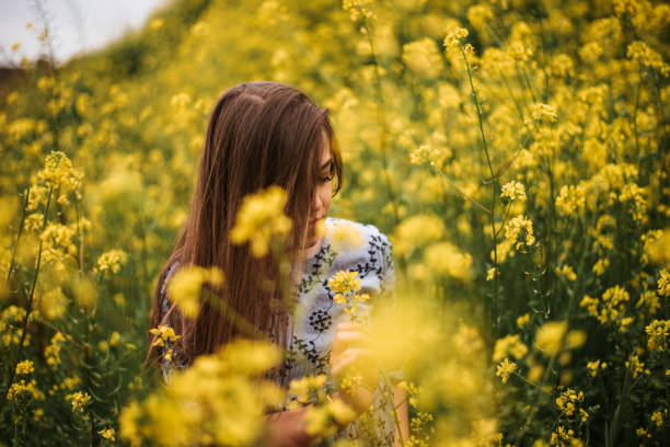 istock Young woman in a flower field 964278546