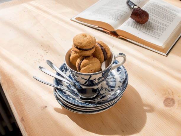 istock Chocolate cupcakes in teacup, book on background. 964280230