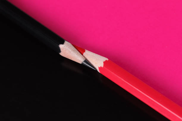istock Red and black Colour pencils isolated on paper 964281476