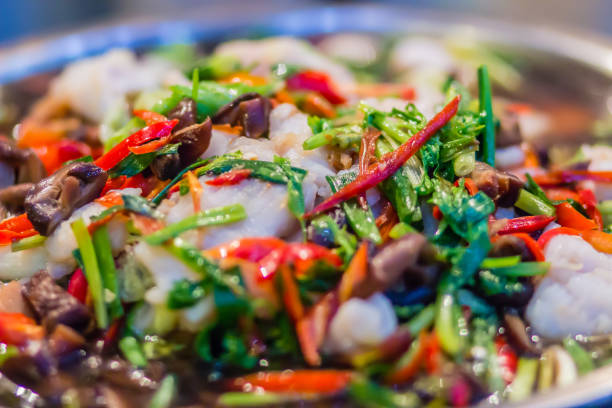 Fish stir fried with variety of vegetables and mushroom for serve in the buffet party in the restaurant.