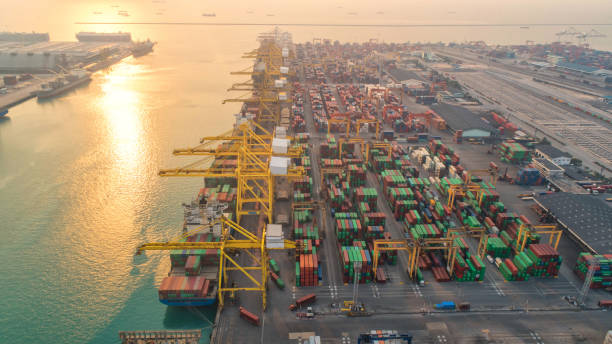 istock Container ship in export and import business and logistics. Shipping cargo to harbor by crane. Water transport International. Aerial view and top view. 964283344