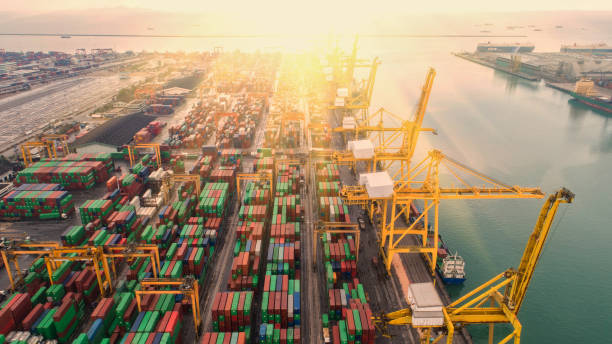 istock Container ship in export and import business and logistics. Shipping cargo to harbor by crane. Water transport International. Aerial view and top view. 964283368