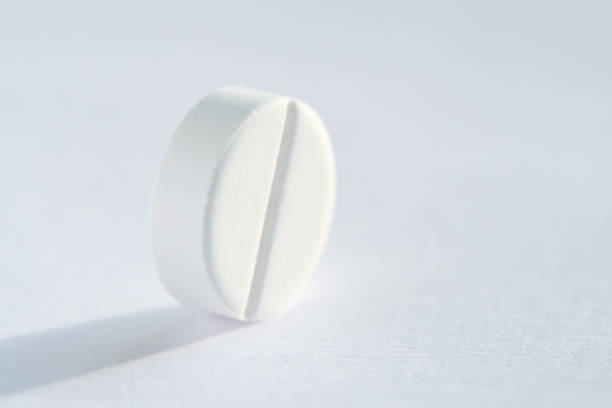 istock Pill tablet medicine lying isolated on white, extreme close-up macro. 964283478