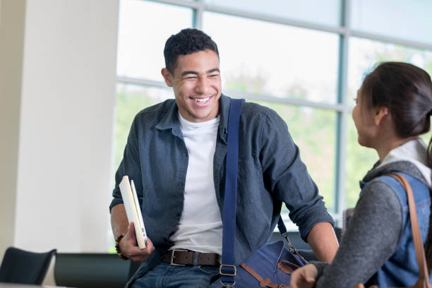 istock Young man flirts with college classmate after class 964283706