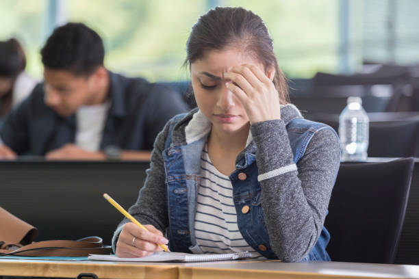 istock Young woman takes difficult college exam 964283714