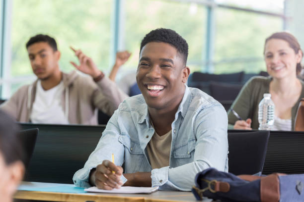 istock Young man enjoys humorous college lecture 964283754