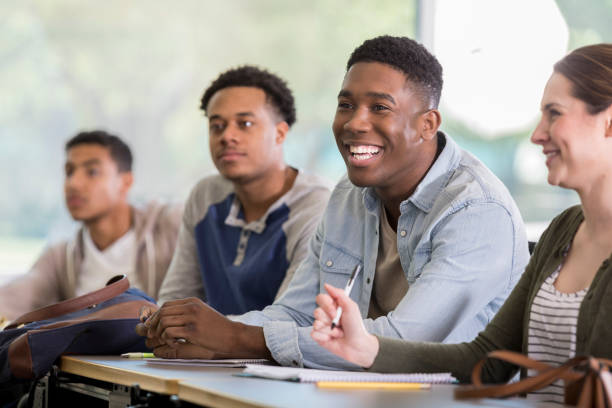 istock Cheerful young man enjoys humorous college lecture 964283768
