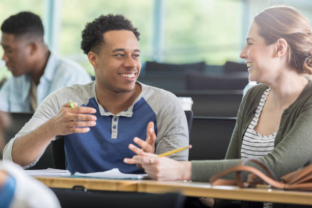 istock Young man share humorous story with female college classmate 964283778