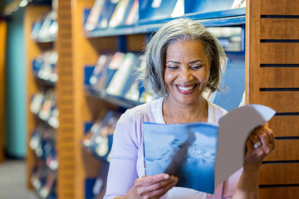 Woman reads magazine in library