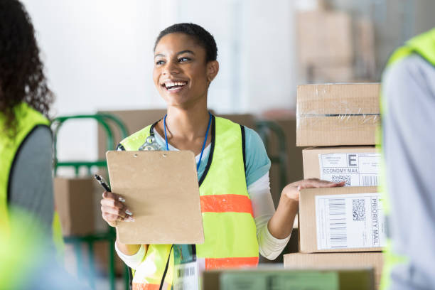 istock Cheerful warehouse manager gives instructions to employees 964286724