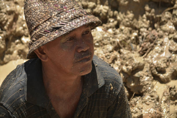 Cempaka, Banjarbaru, South Borneo. April 22, 2018\n\nSotani, a 50-years-old diamond miner, is one of the senior traditional diamond hunters. He left school in the 3rd grade where he eventually became a diamond miner. He and other people from his village believed that this job will bring them to a prosperous life, rather than sticking to school.
