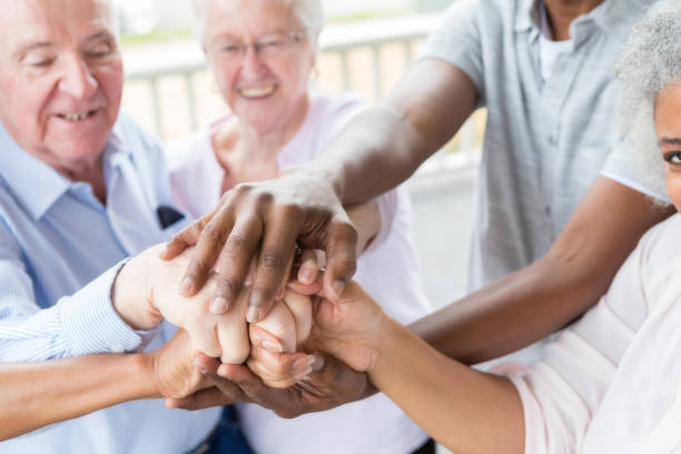 istock Senior adults with hands stacked together 964288184