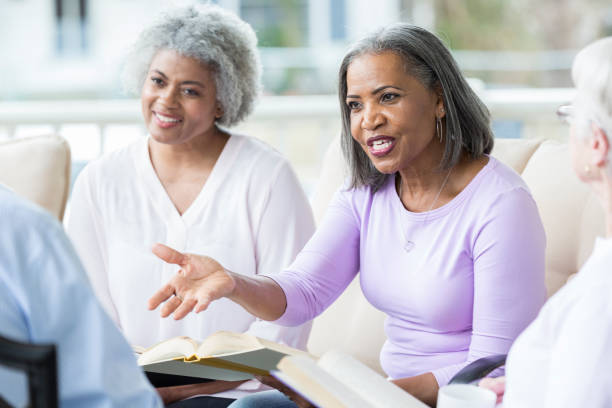 istock Senior women gestures while discussing Bible verse 964288224
