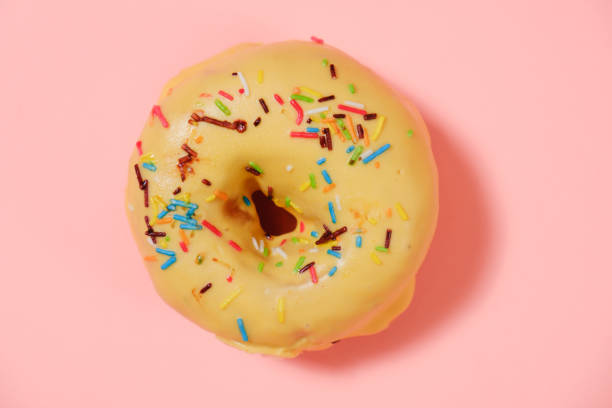 istock Delicious donut on pink background 964288342