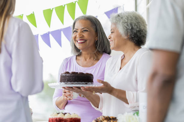 istock Women donate cake to bake sale 964288364