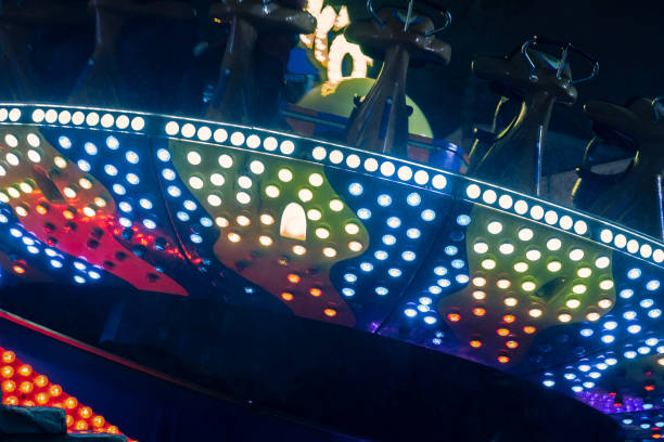 istock Amusement park at night - carousels and attractions in motion 964289088