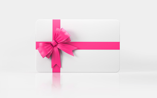 White gift card with pink bow tie on white background. Horizontal composition with copy space.