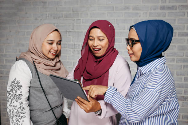 istock Asian women looking at social media on a digital tablet 964301588
