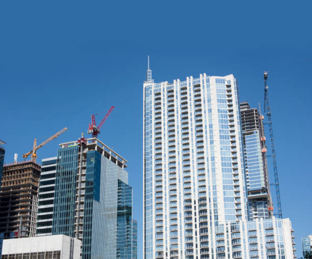 istock New skyscrapers under construction with tall cranes 964301912