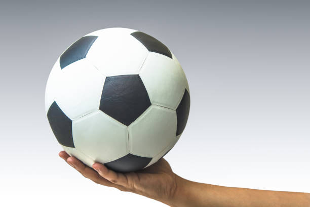 istock Hand with a soccer ball isolated on white 964305098