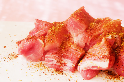 Fresh uncooked meat on pink minimal background. Flat lay. top view.