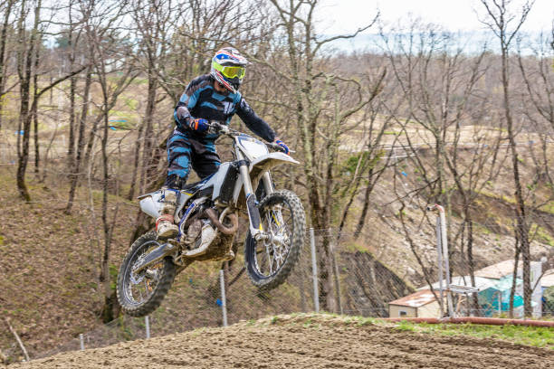 istock racer on a motorcycle in flight, jumps and takes off on a springboard 964312694