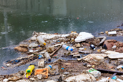 Istanbul, Turkey - May 27, 2018: Water Pollution - Polluting the Seas. Plastic waste floating in a canal in Istanbul, Turkiye.