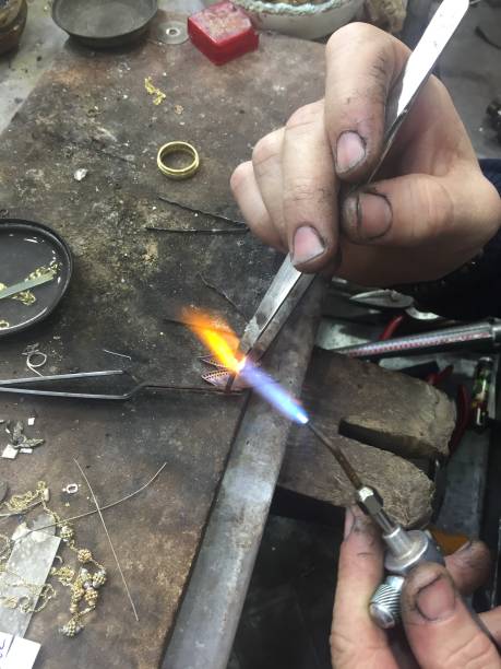 istock Goldsmith is repairing a gold ring 964317978