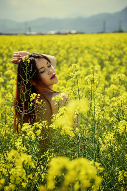 istock Girl in colza field 964318784