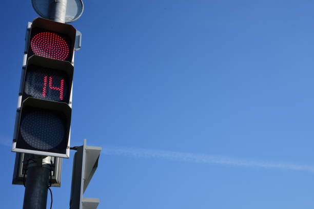 istock Red traffic light  with a beautiful blue sky in background 964321374