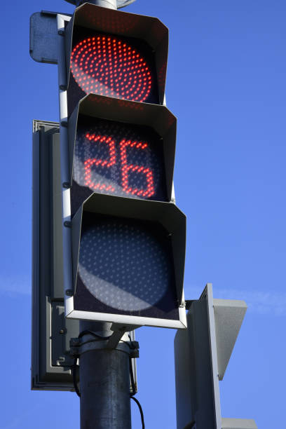 istock Red traffic light  with a beautiful blue sky in background 964321392