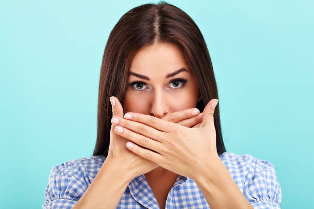 istock Woman against blue wall background 964325558
