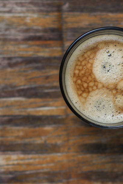 istock black coffee and foam in a transparent steklnny cup (portion of hot coffee) 964325576
