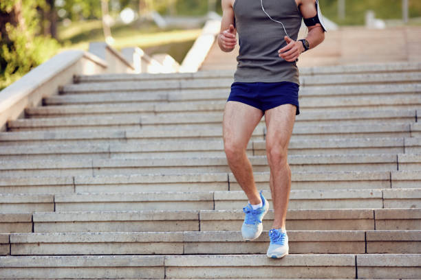 istock A  male runner runs down the steps in the par 964328340