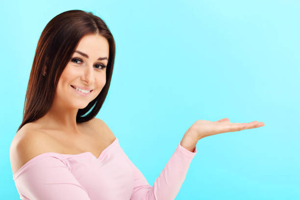 istock Woman against blue wall background 964329302