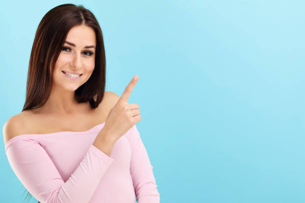 istock Woman against blue wall background 964329334
