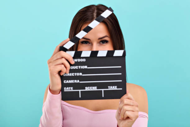 istock Woman against blue wall background 964330914