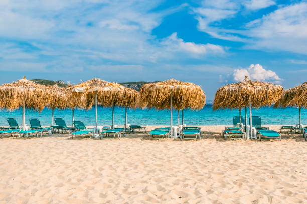 Summer scenery with blue sunbeds and umbrellas. Summer destinations background