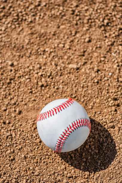 istock Looking down on a new baseball sitting in the dirt 964339982