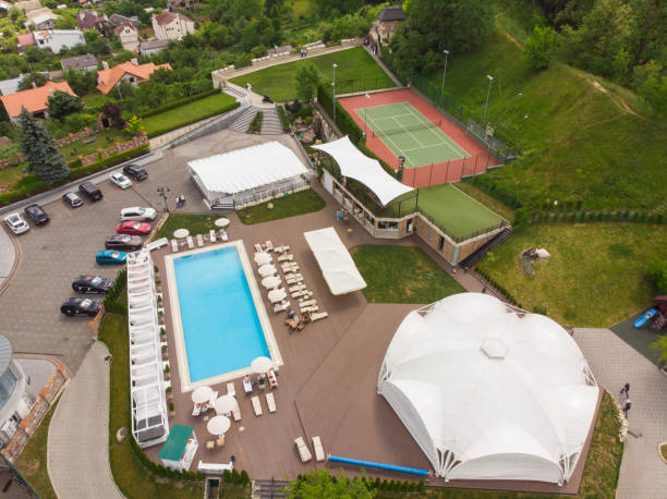 istock luxury resort with pool in forest. aerial view 964357262