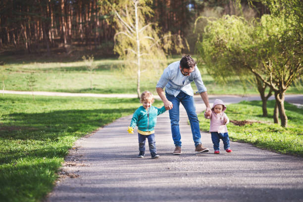 istock A father with his toddler children outside on a spring walk. 964357628