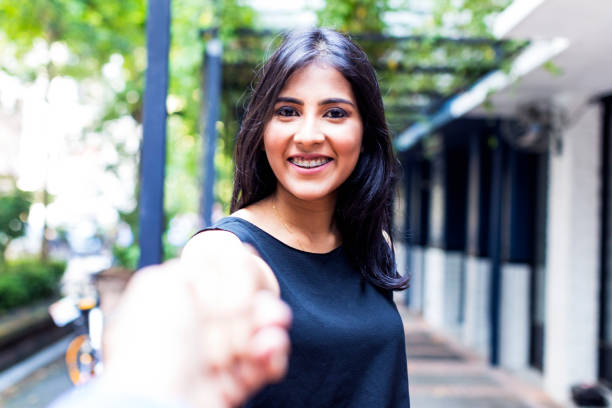 Asian girl holding hand and saying goodbye