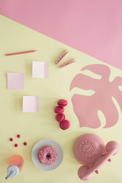 istock Pink phone on yellow background 964369926