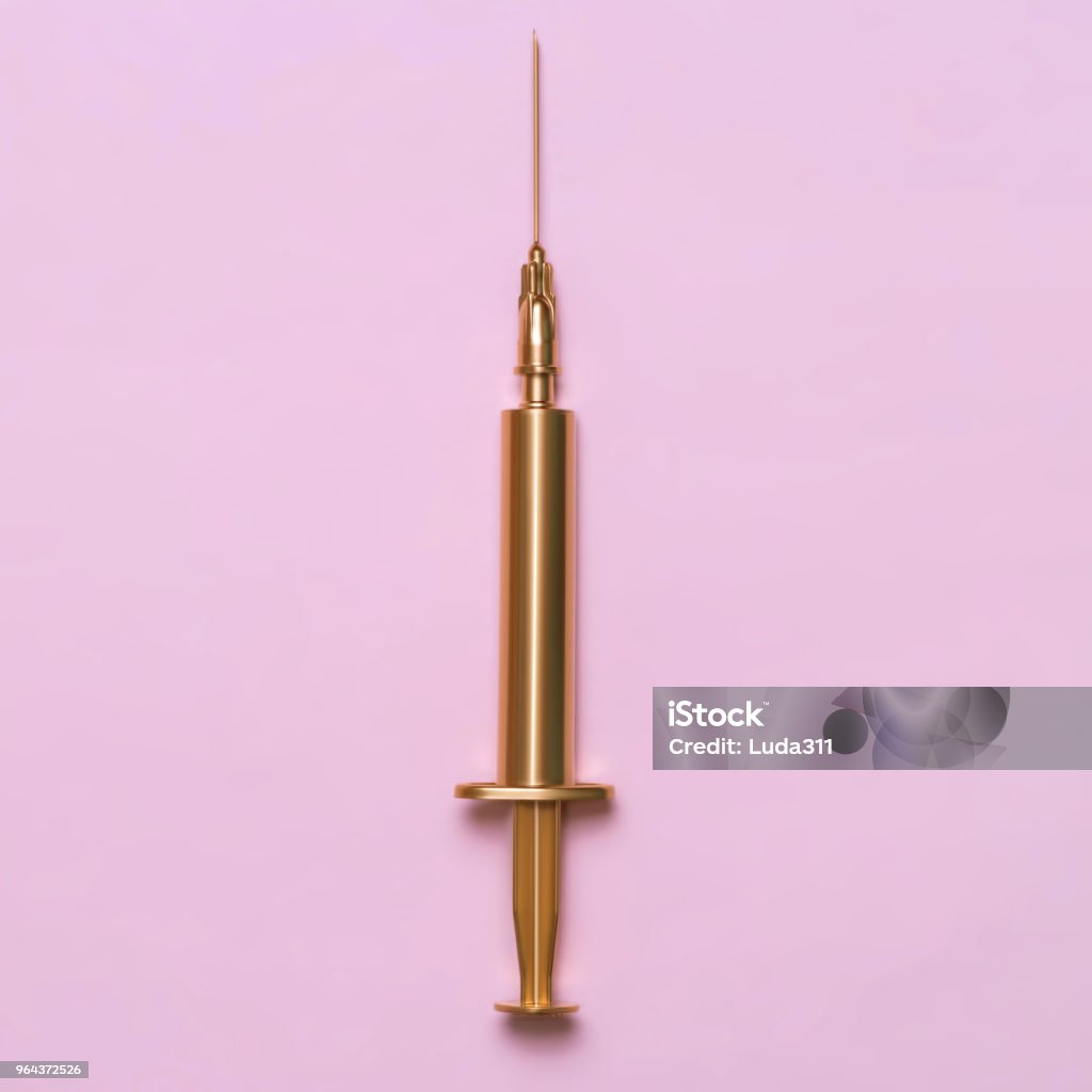 Golden syringe on a pink background. Medical item. Minimalism concept Golden syringe on a pink background. Medical item. Minimalism concept. Syringe Stock Photo