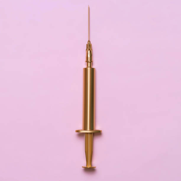 Golden syringe on a pink background. Medical item. Minimalism concept Golden syringe on a pink background. Medical item. Minimalism concept. needle plant part stock pictures, royalty-free photos & images