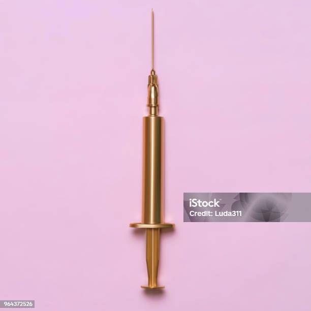 Golden Syringe On A Pink Background Medical Item Minimalism Concept Stock Photo - Download Image Now