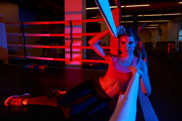 istock Woman in sportswear lying on boxing ring 964380204