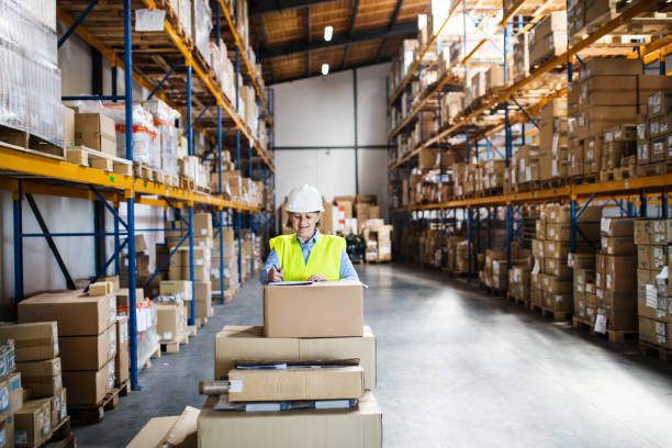 istock A senior woman warehouse worker or supervisor controlling boxes. 964380706