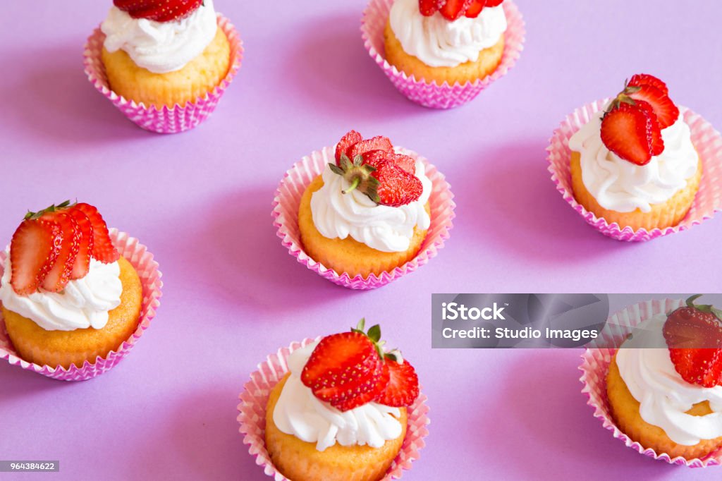 Strawberry cupcakes Strawberry cupcakes on purple background Dough Stock Photo