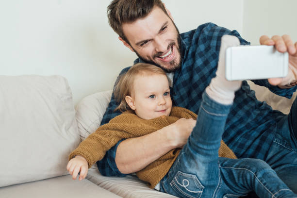 istock Baby girl blocking selfie camera with her leg 964384734